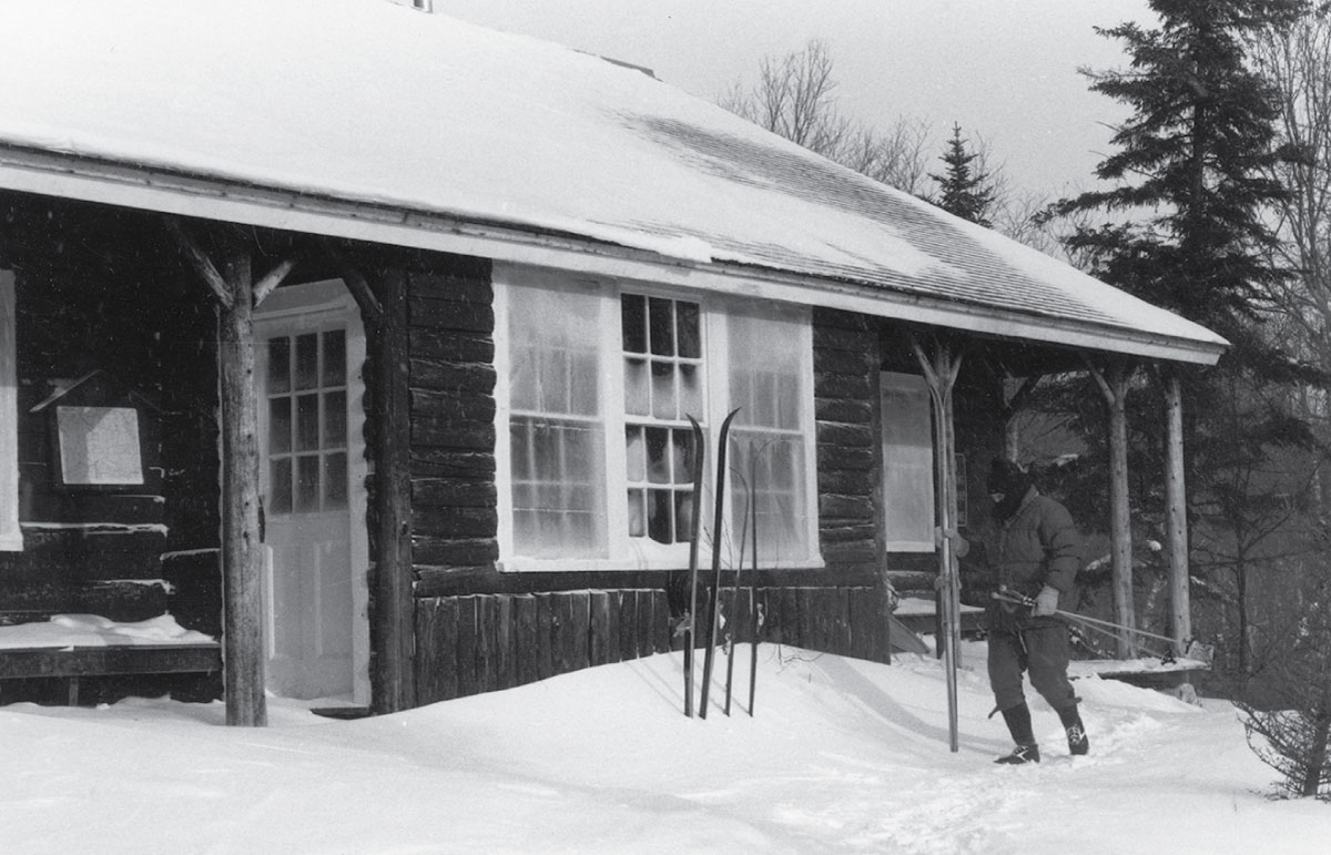 A skier outside Zealand Falls Hut