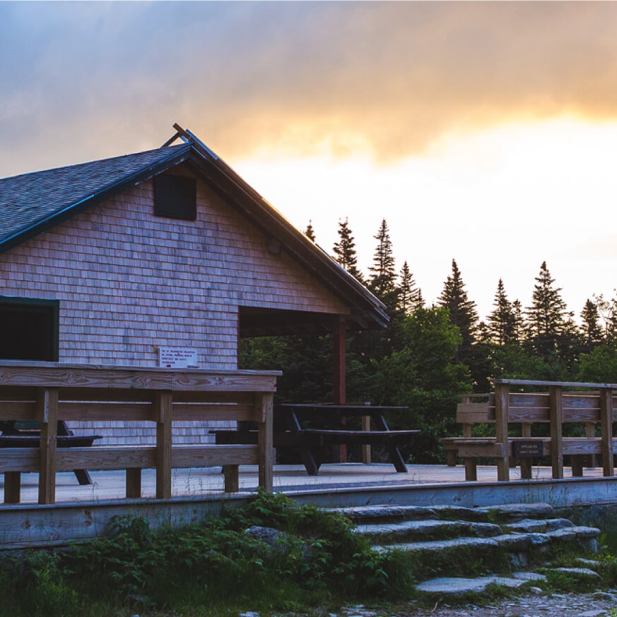 View of Hermit Lake Shelters under a cloudy sky