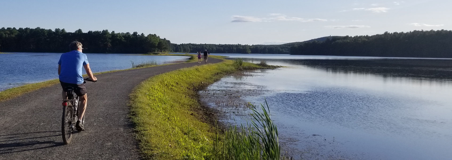 A bikers rides along the shore of Ashley Reservoir