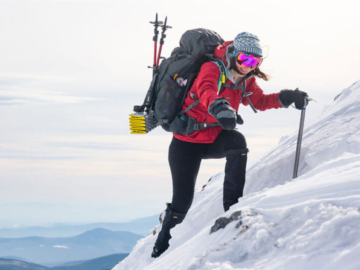 Hiker climbing in winter