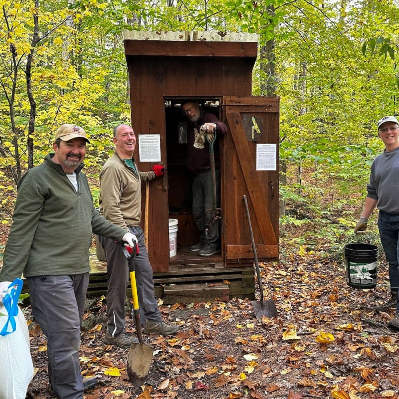 Volunteers performing maintenance at a cabin