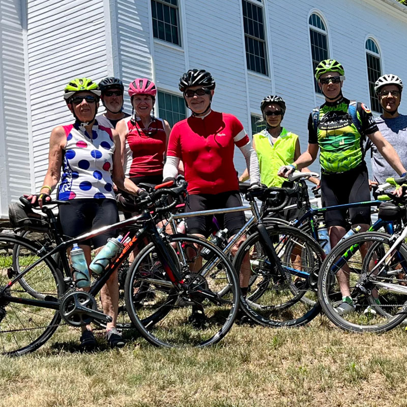 Cyclists pose for a photograph