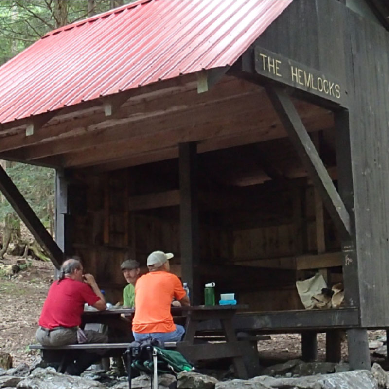 Hikers picnicking at the Hemlocks Shelter