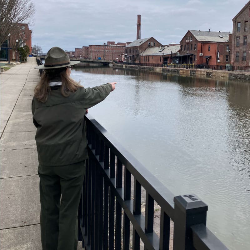 Park interpreter pointing out mills