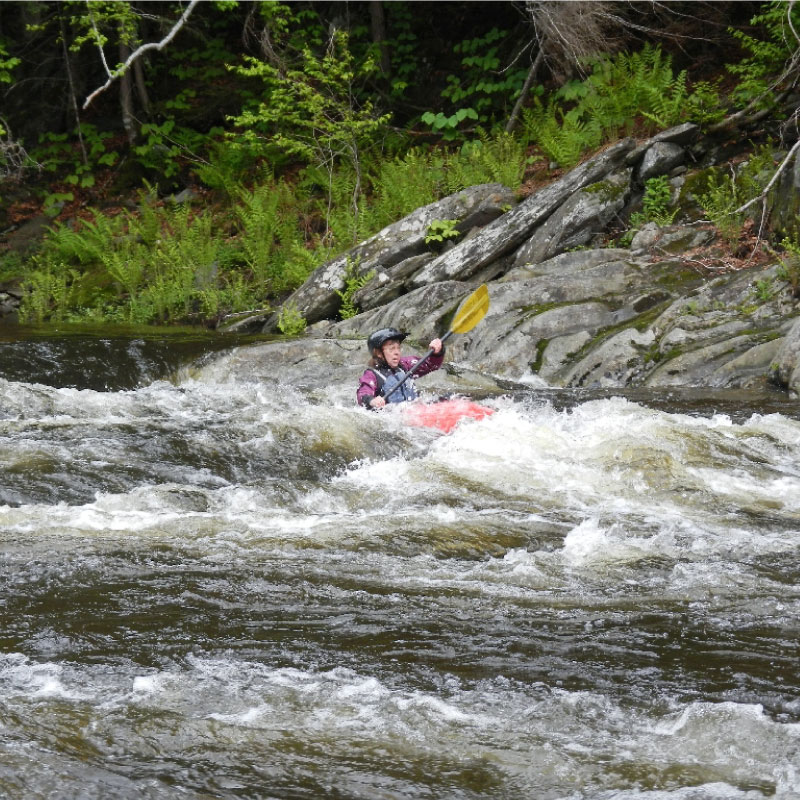 Kayaker running rapids