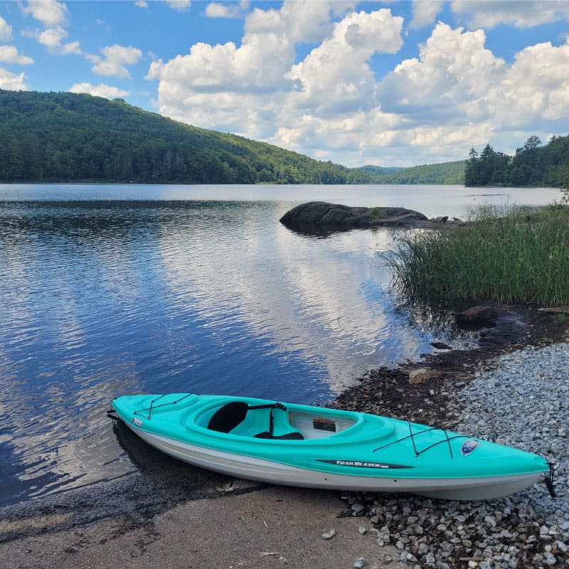 Kayak on the shore of a pond