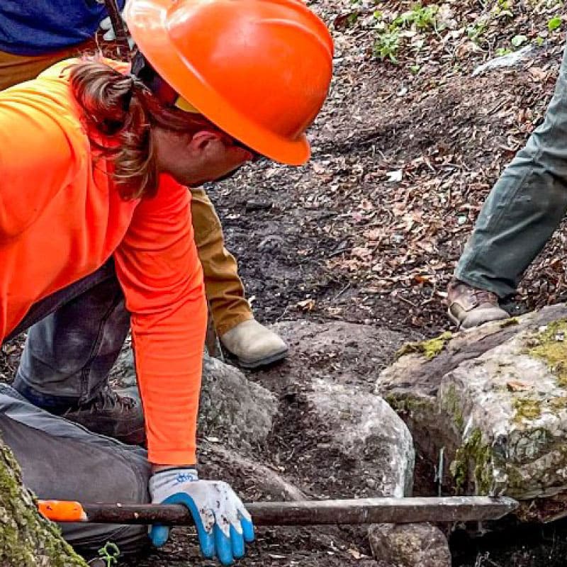 Trails crew clearing rocks from a trail