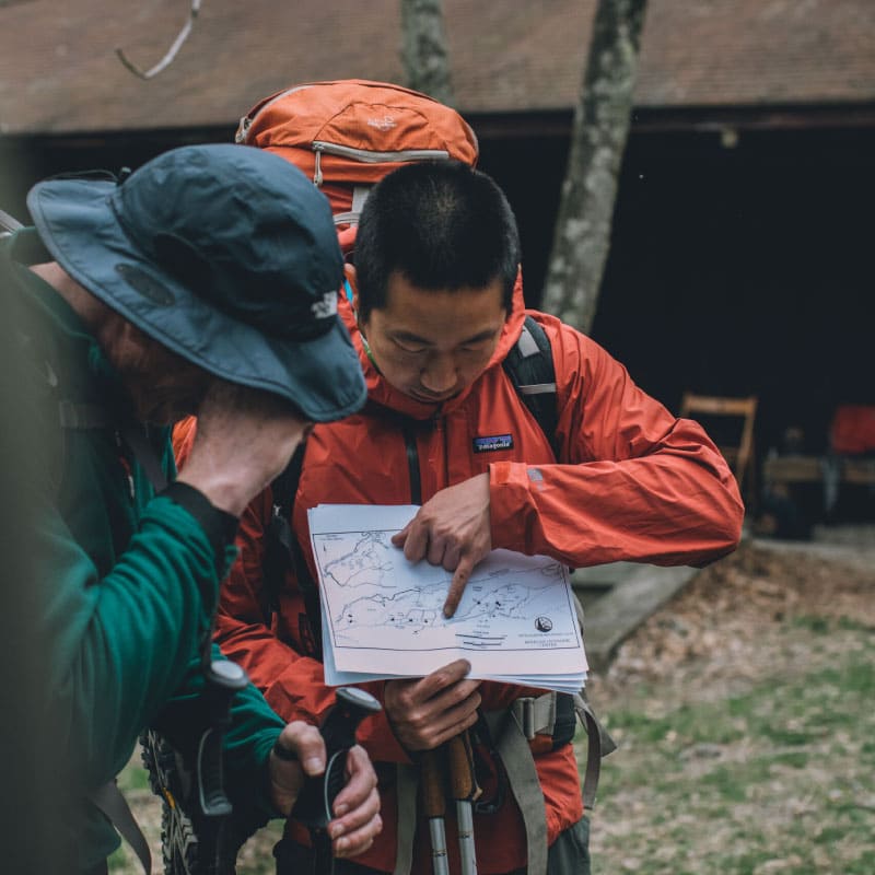 Hikers examining a map