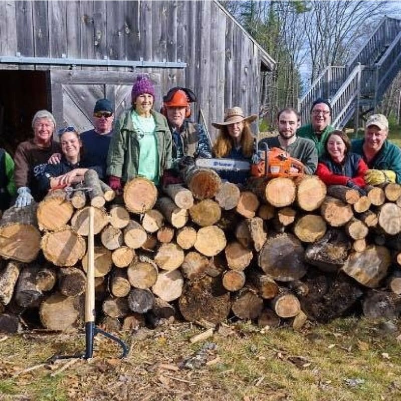 Volunteers stacking wood