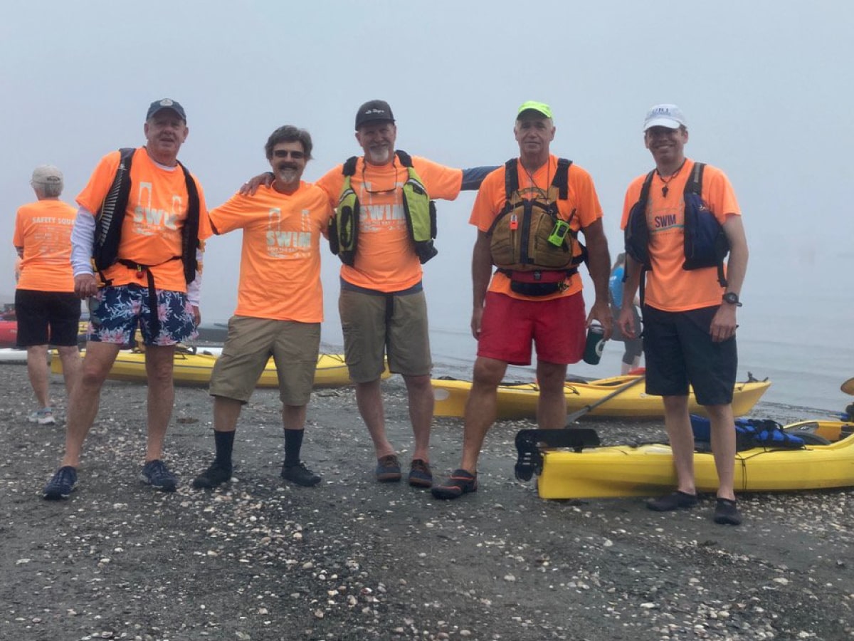 Front cover: Kayakers pose for a photo on a beach