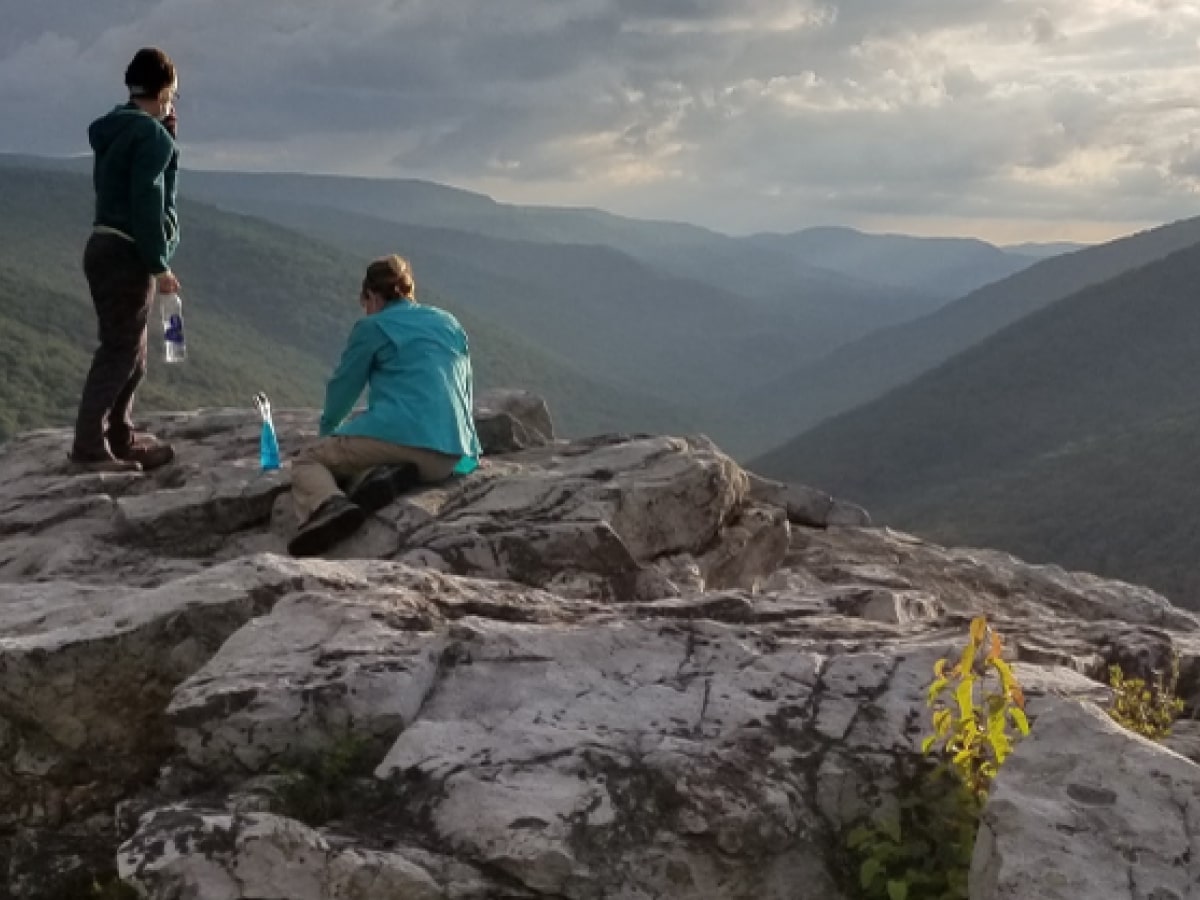 Back cover: Hikers admiring the view from a rocky outcrop