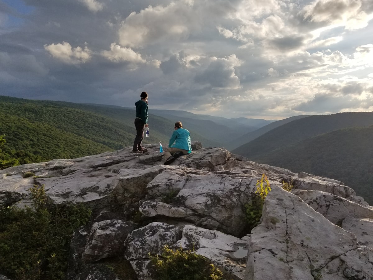 Front cover: Hikers admiring the view from a rocky outcrop