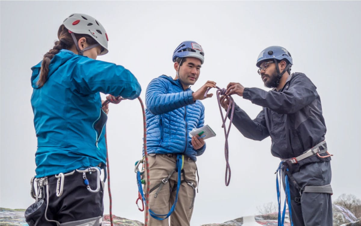 Teacher instructs students in rope tying