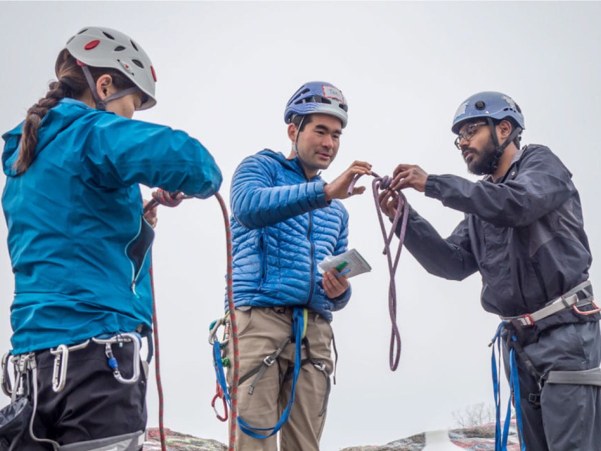 An instructor teaches students how to tie knots