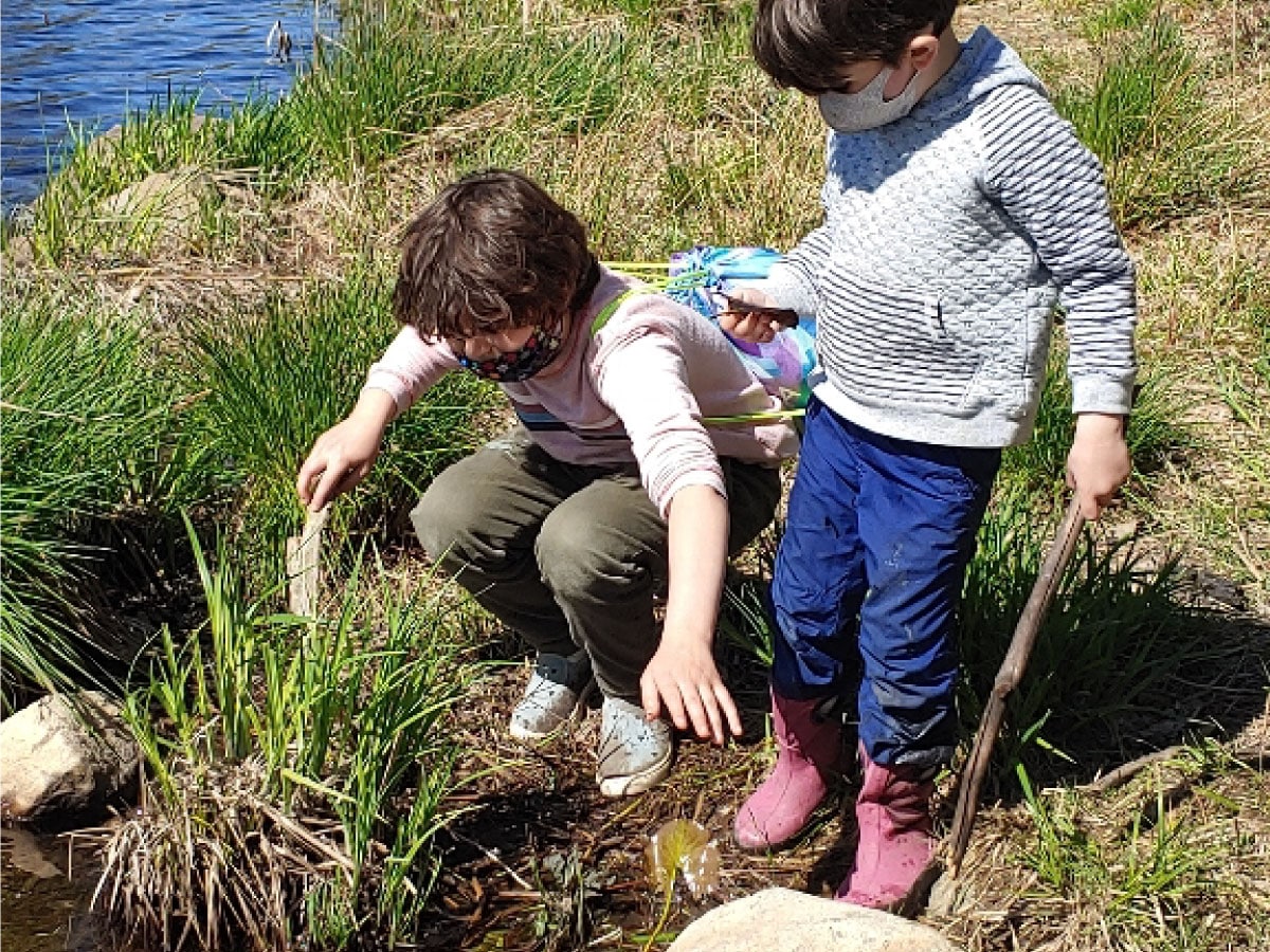 Children play along a lake shore
