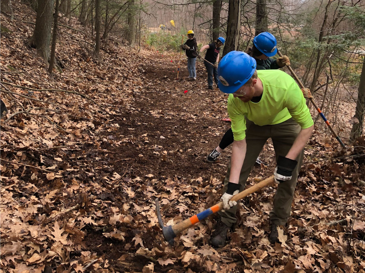 Volunteers work on a new trail connection