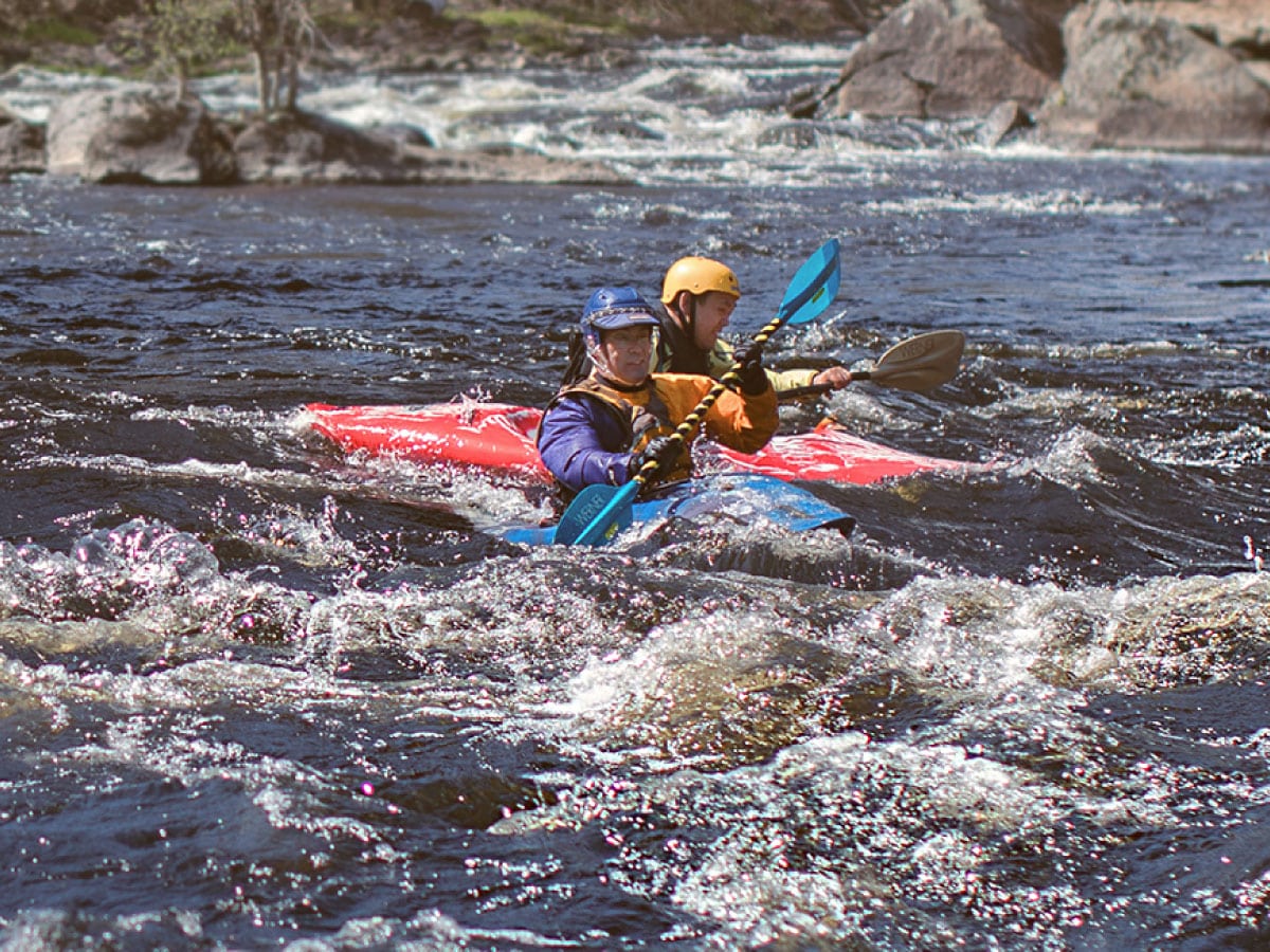 Kayakers running rapids