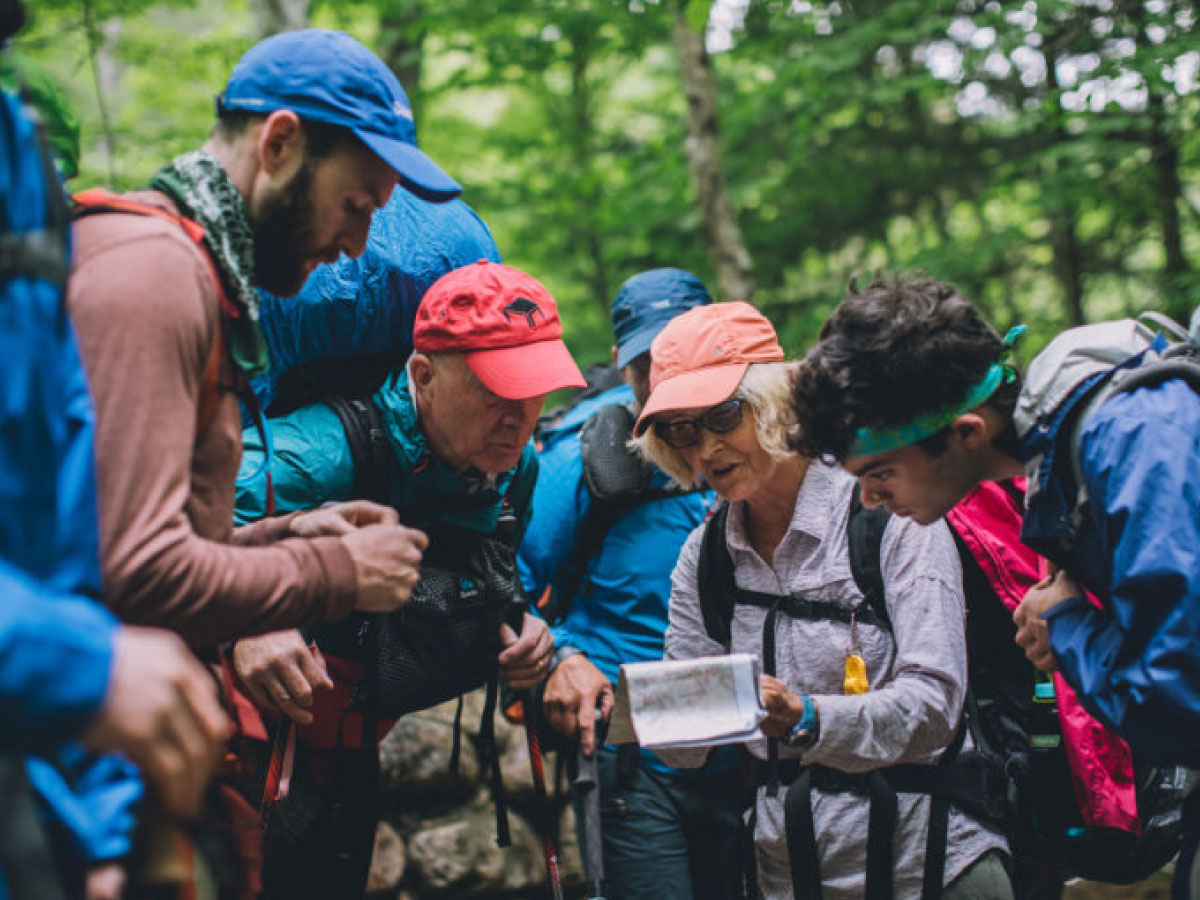 A hiking party looks over a map together