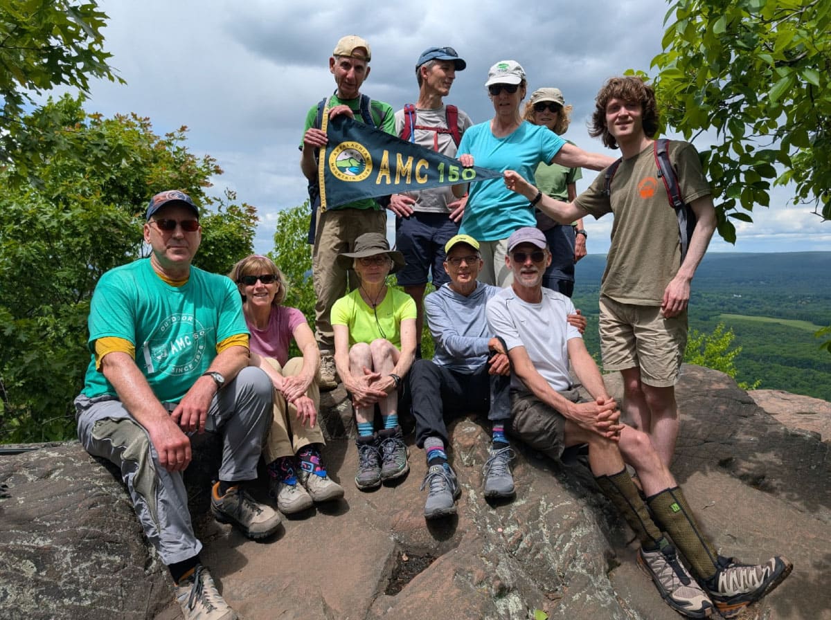 Hikers with the AMC 150 Relay banner