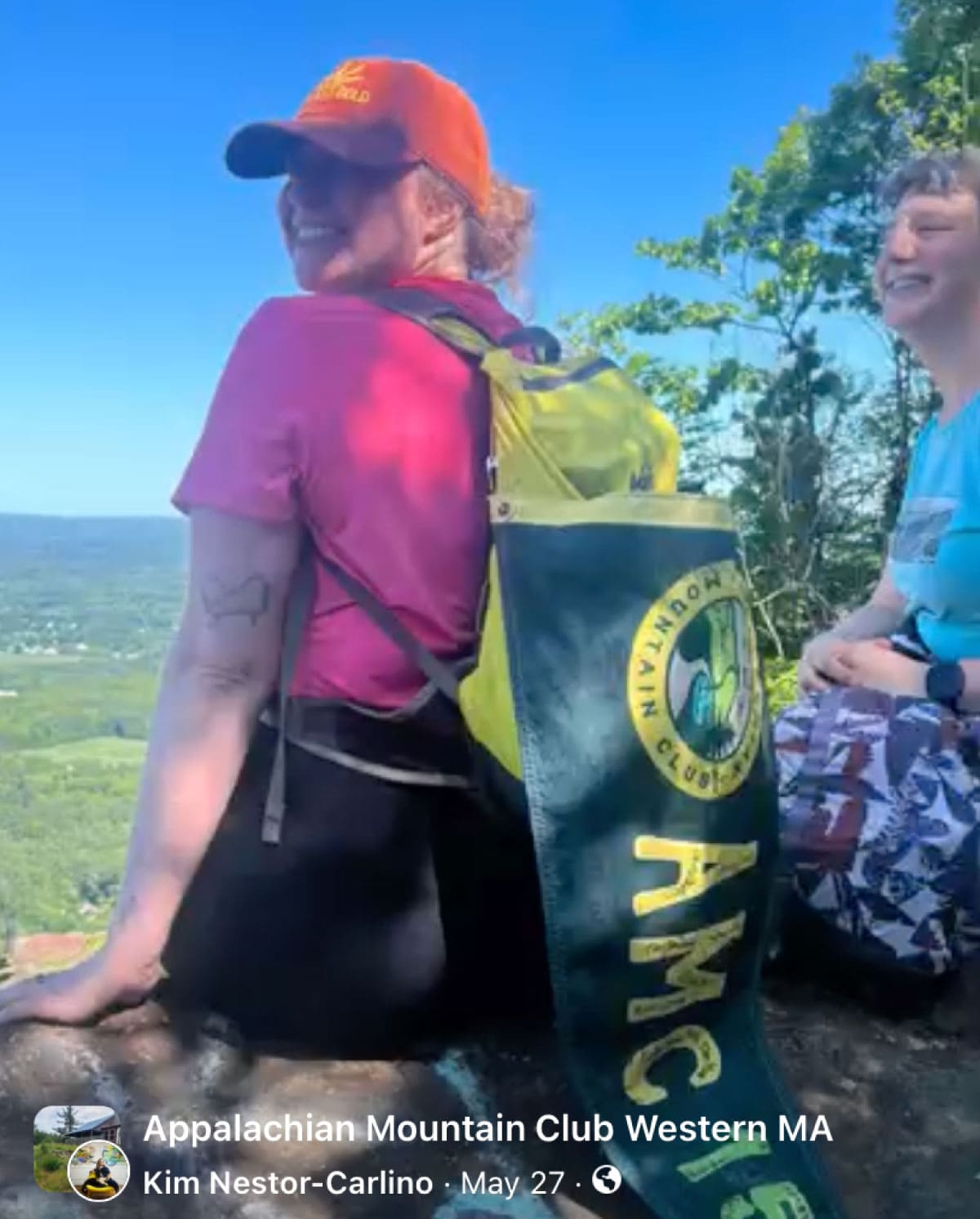 Hiker with the AMC 150 Relay banner