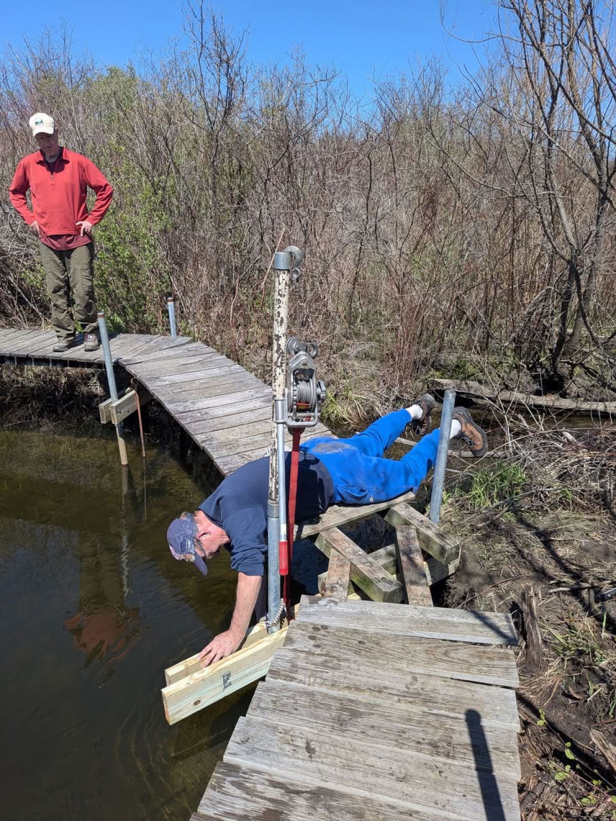 AMC members repairing a trail bridge