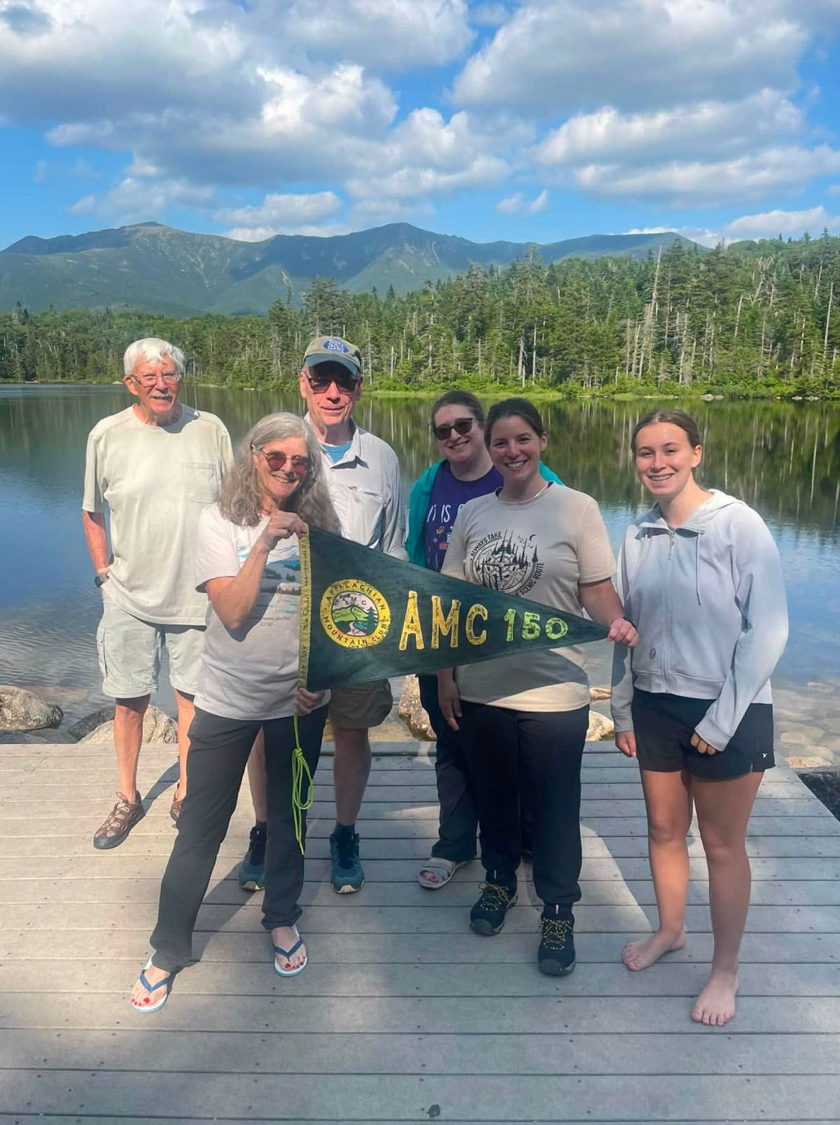 Hikers posing by a lake
