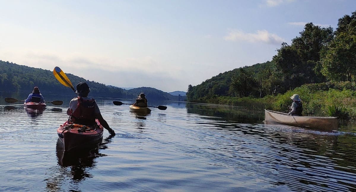 Paddlers canoeing and kayaking on a river