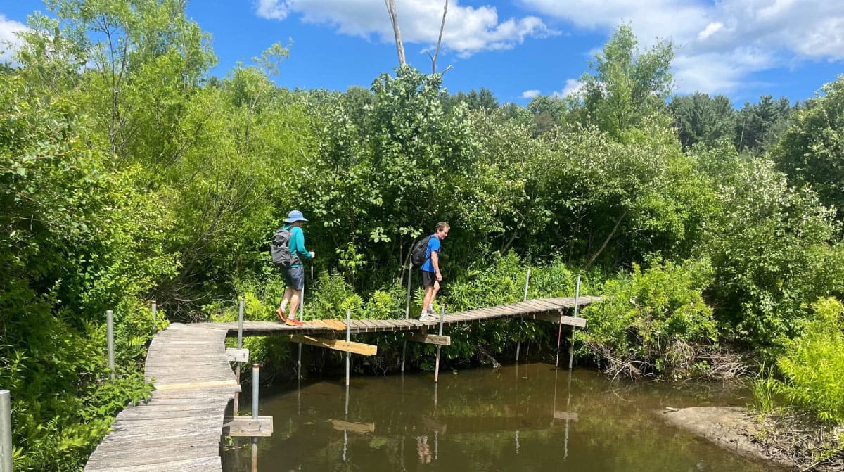 Hikers crossing a bridge