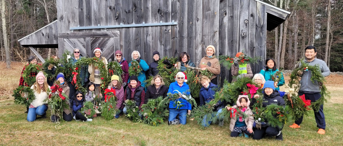 Participants in the decorations workshop show their wreaths