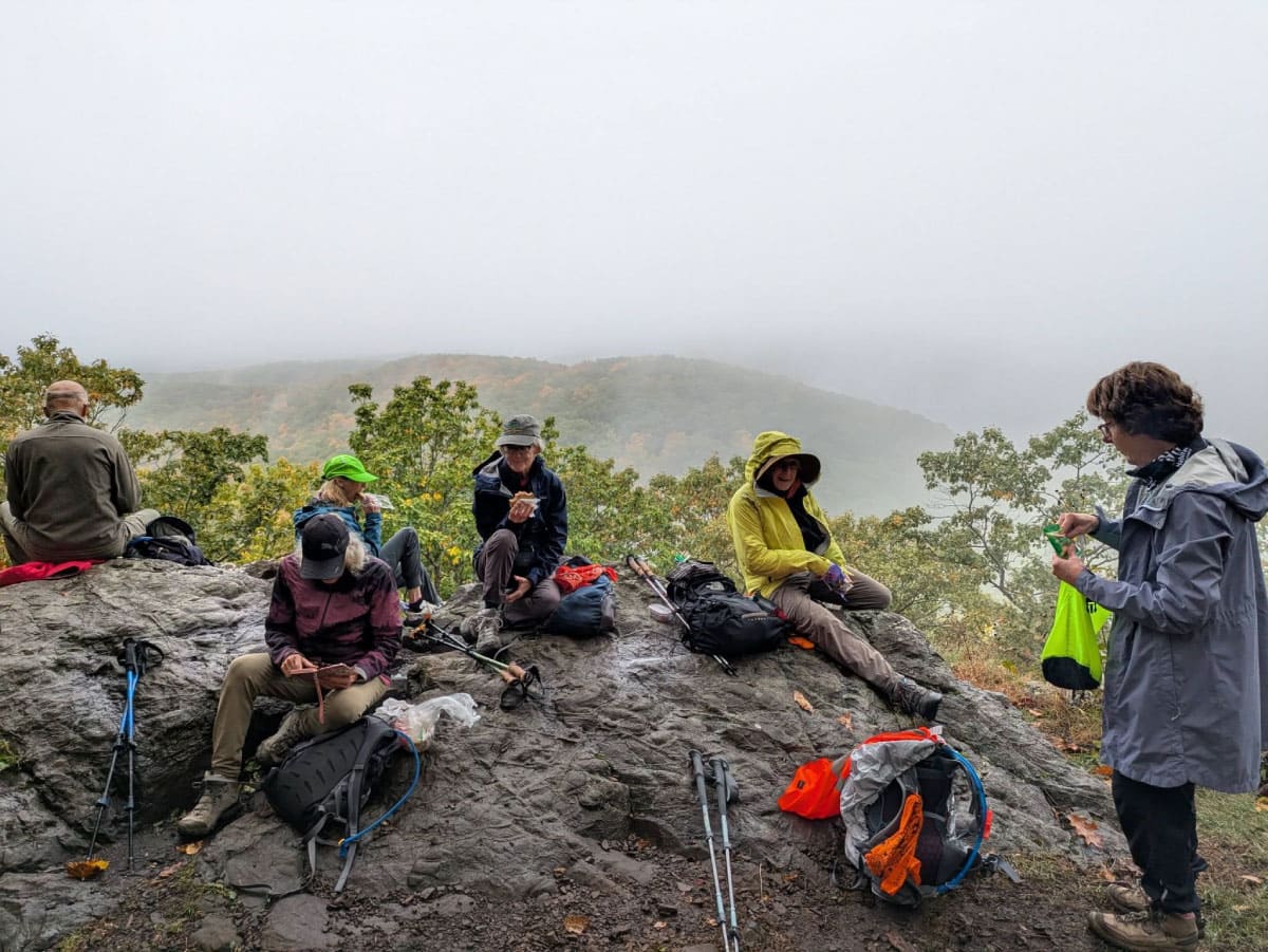 Hikers eating lunch in fog