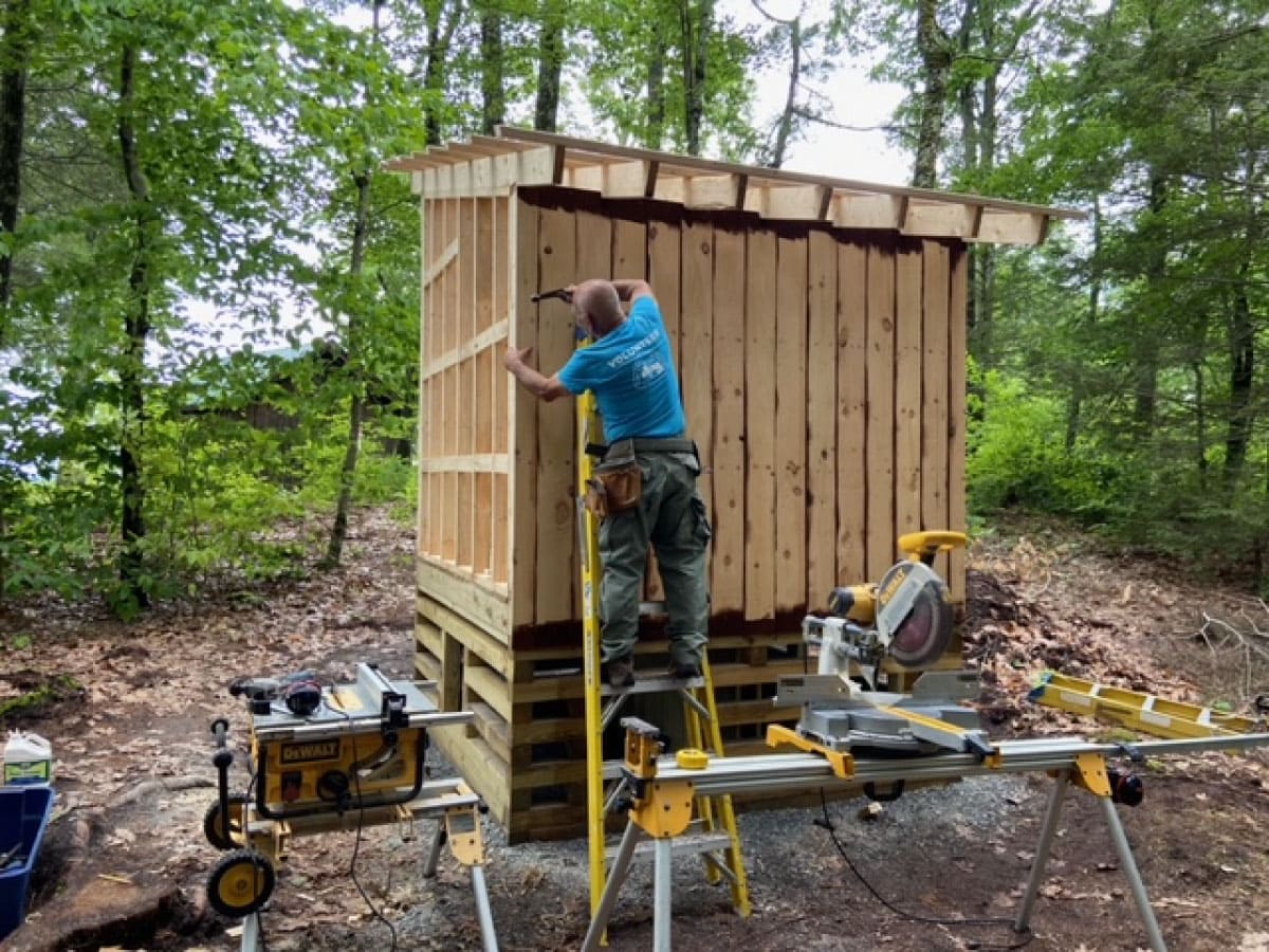 Workers building a privy
