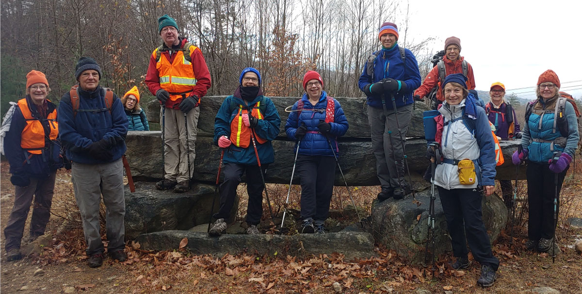 Hikers pose for a photo op on a fall day