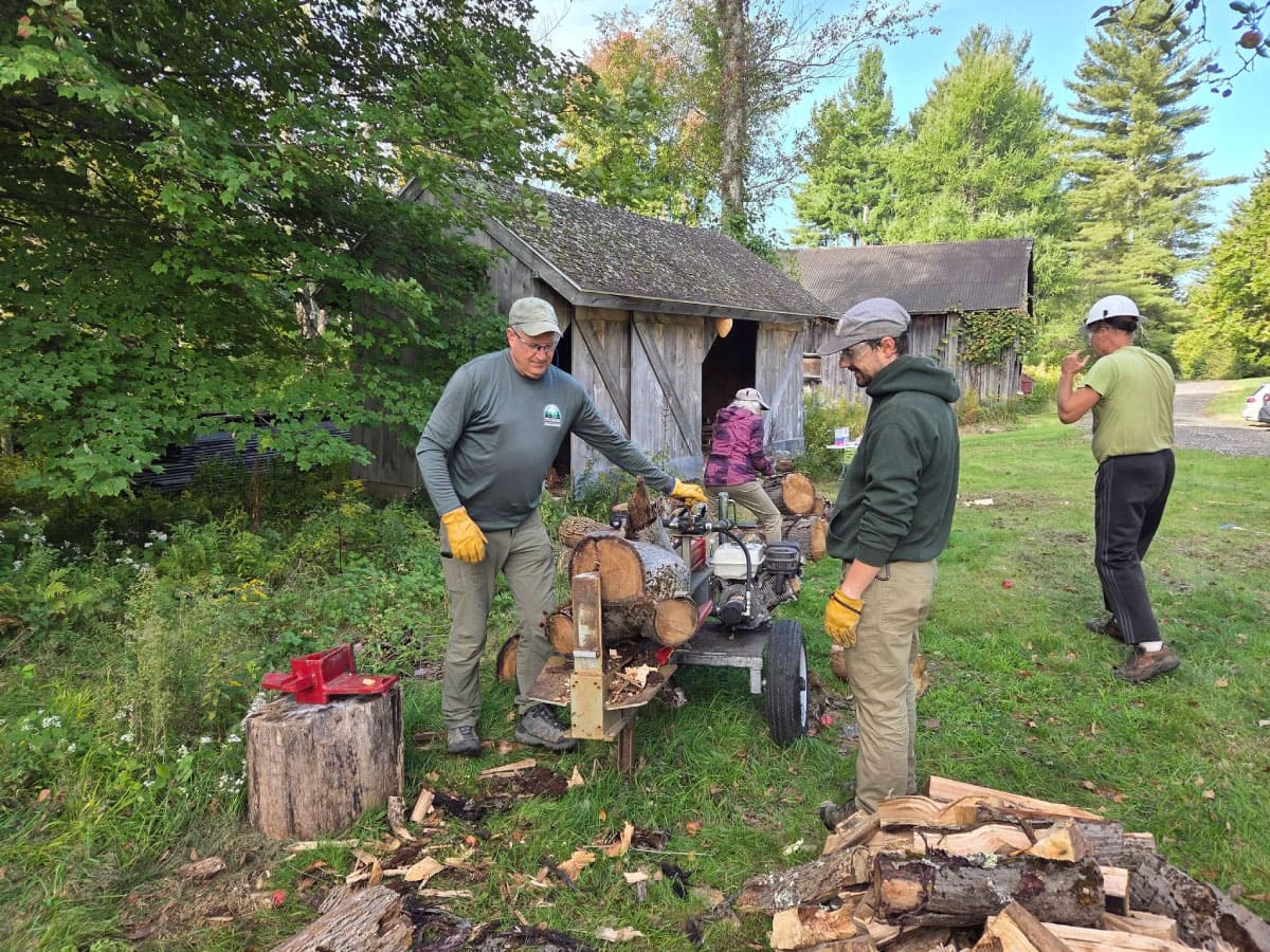 Volunteers splitting firewood