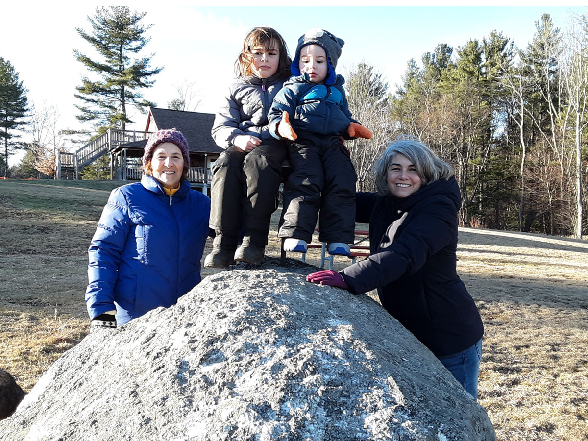 A family posing on a rock at Noble View