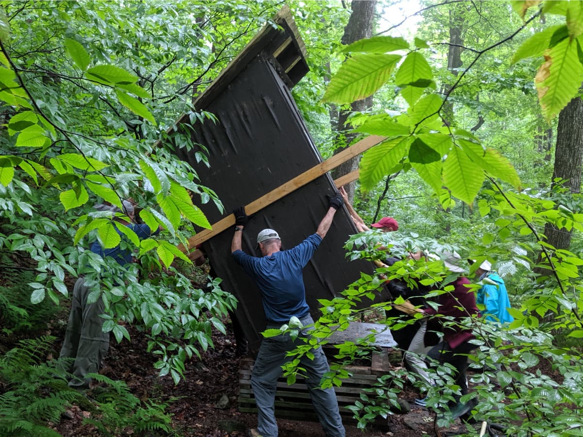 Workers maintaining the Kay Wood Shelter privy