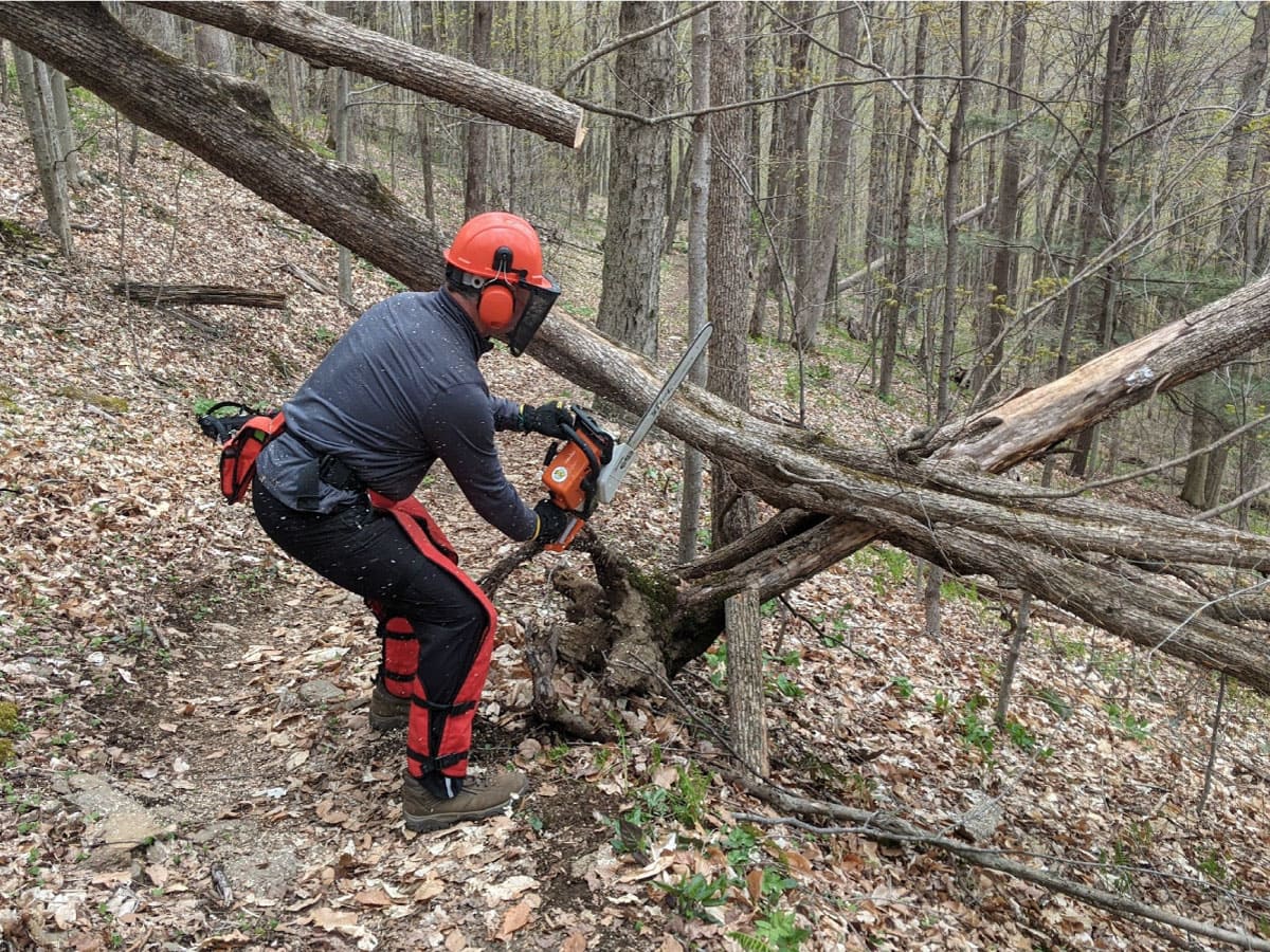 Josh Weeks clears blowdown on the trail