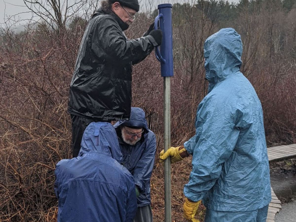 A trail crew repairs a boardwalk over a wet area on the A.T.