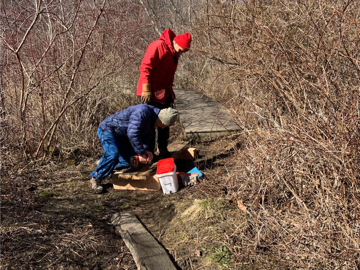 Volunteers repairing a bog bridge