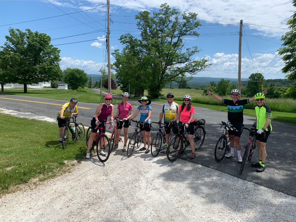 Cyclists pose for a photo in Cooper Hill