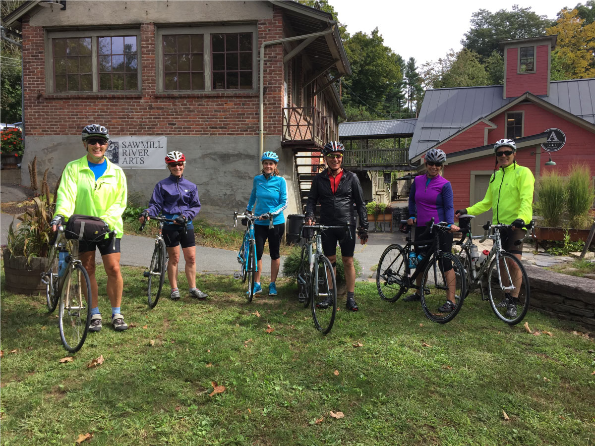 Cyclists pose for a photo at Sawmill River Arts