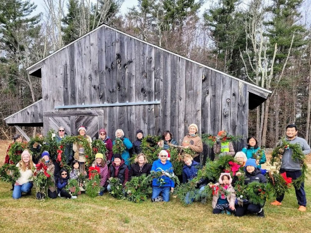 Group poses with their handmade holiday decorations at Noble View