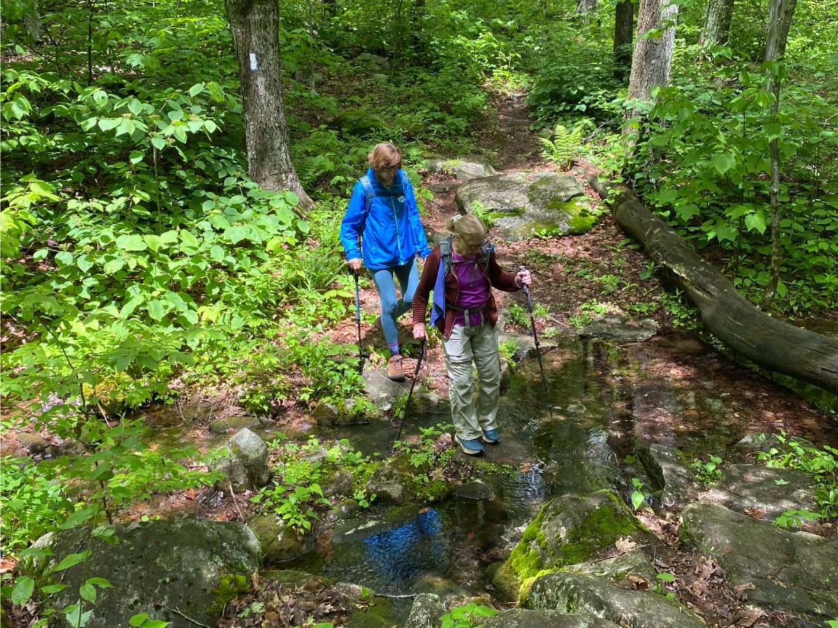 Hikers crossing a stream