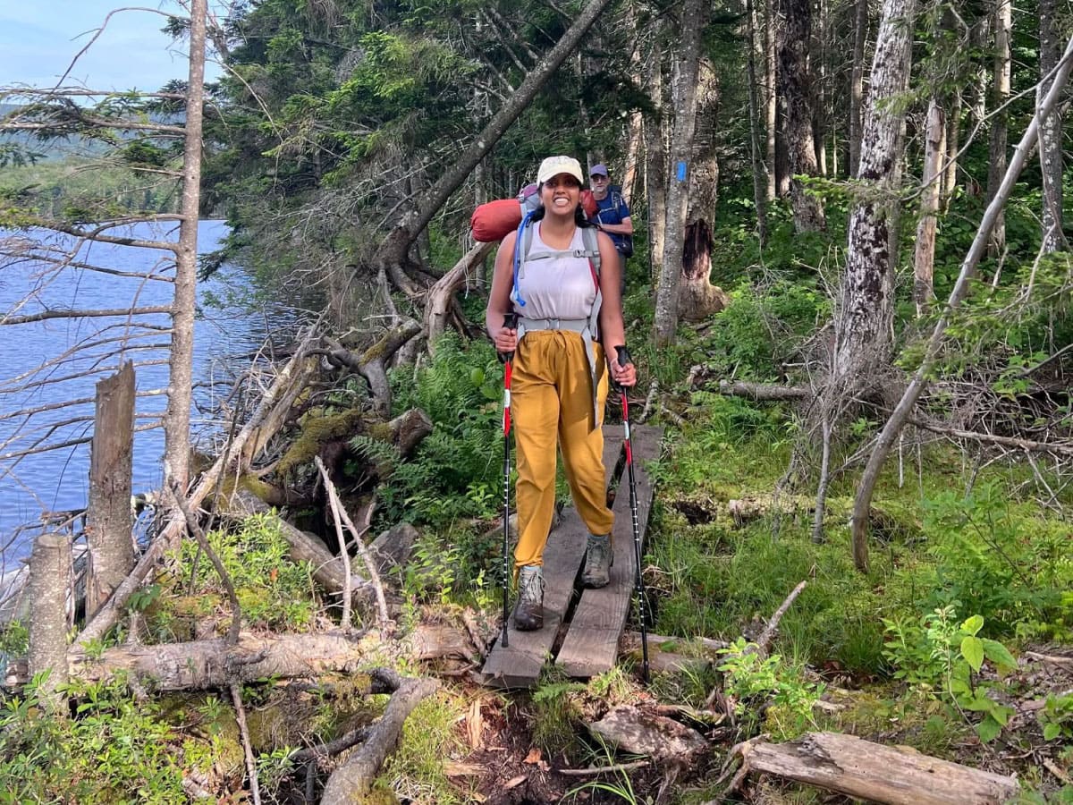 A hiker crossing a boardwalk