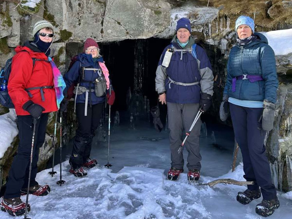 Hikers standing in front of an adit