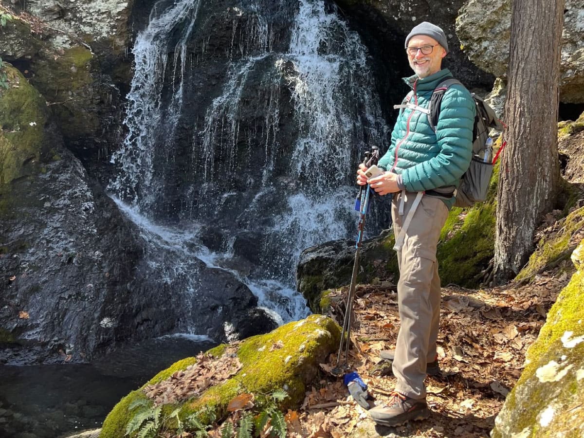 Hiker standing near a waterfall