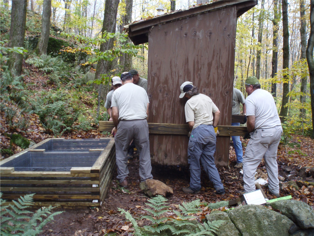 Moving the privy onto the cribbed foundation