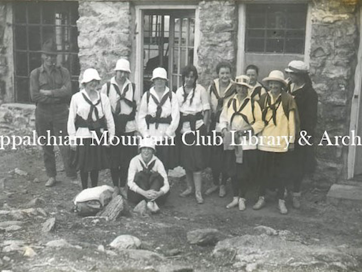 Milton E. MacGregor stands with a group from Camp Aloha