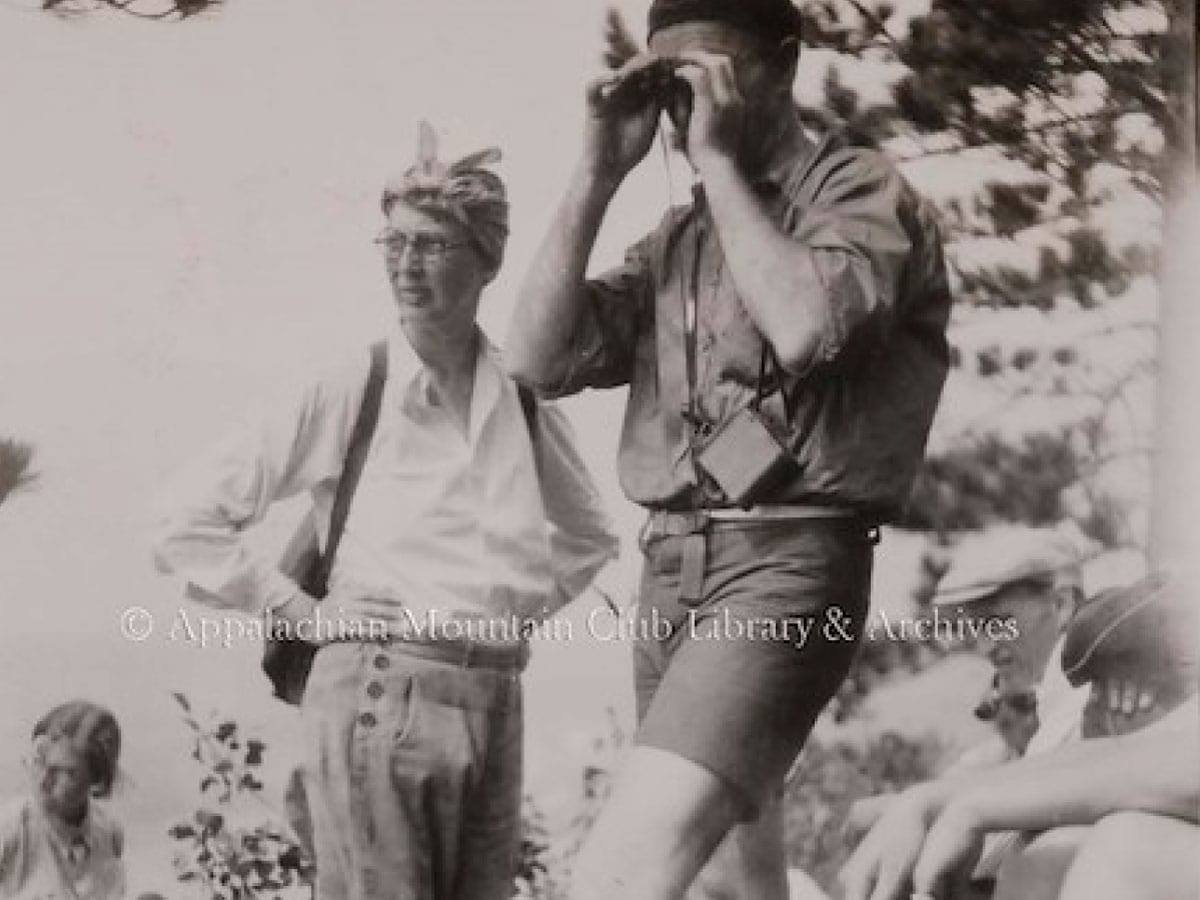 A man looking through binoculars