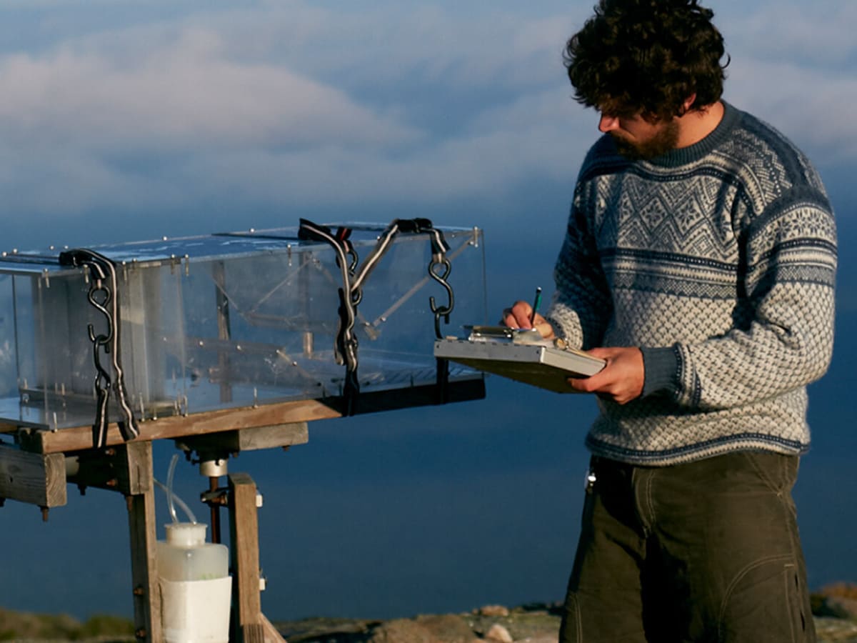 A scientist collects cloud data on Mt Washington