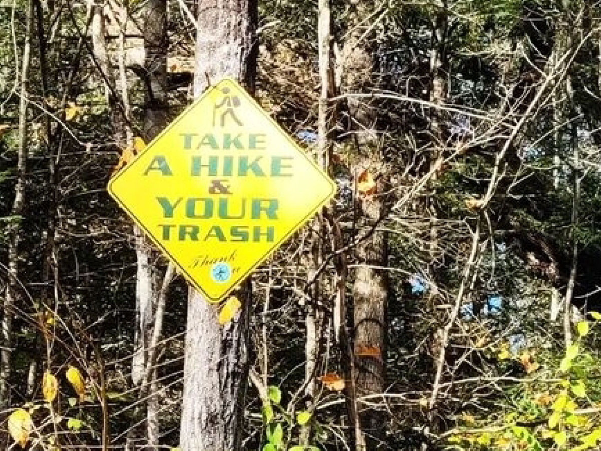 Trail sign: take a hike & your trash